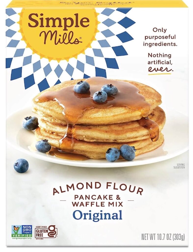 A box of Simple Mills almond flour and pancake waffle mix, the box has a stack of pancakes on the cover topped with maple syrup and blueberries.