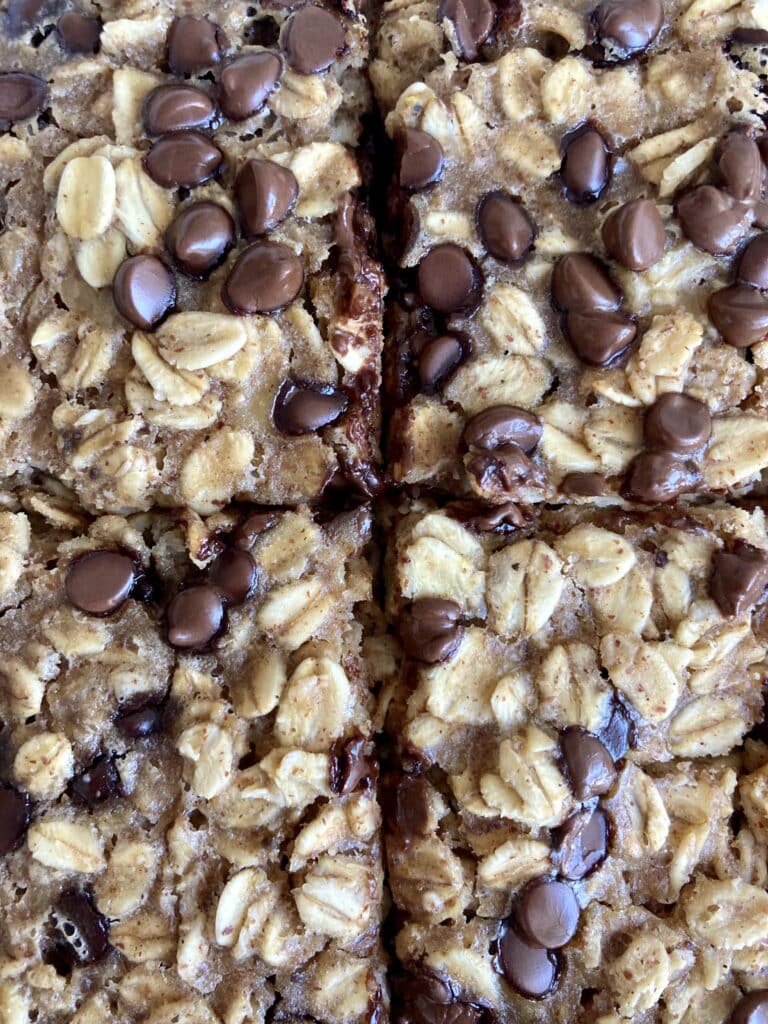 A top down picture of cookie dough baked oats in a casserole dish. split into 4 squares.