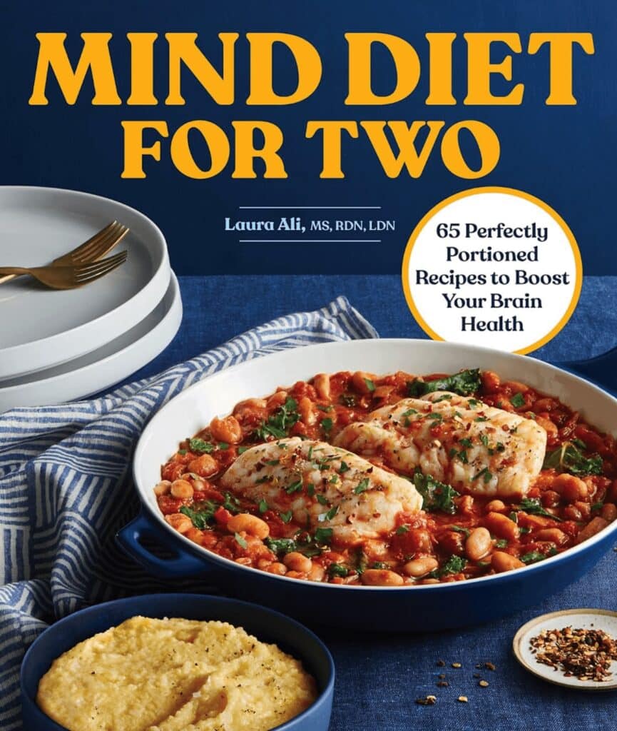 A cookbook called "MIND Diet For Two", with a navy cooking dish with beans and fish on the cover.