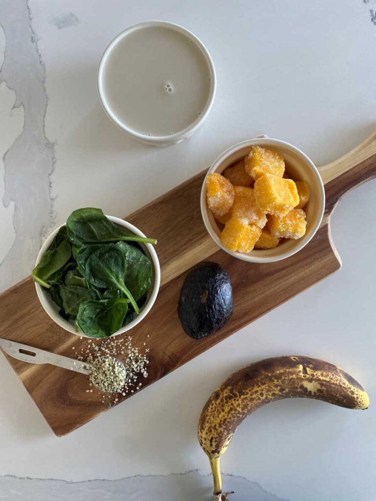 High potassium smoothie ingredients presented on a white counter on top of wood cutting board.