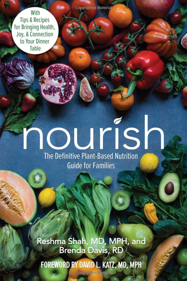 Nourish plant based cookbook cover full of pictures of vegetables of the rainbow. 