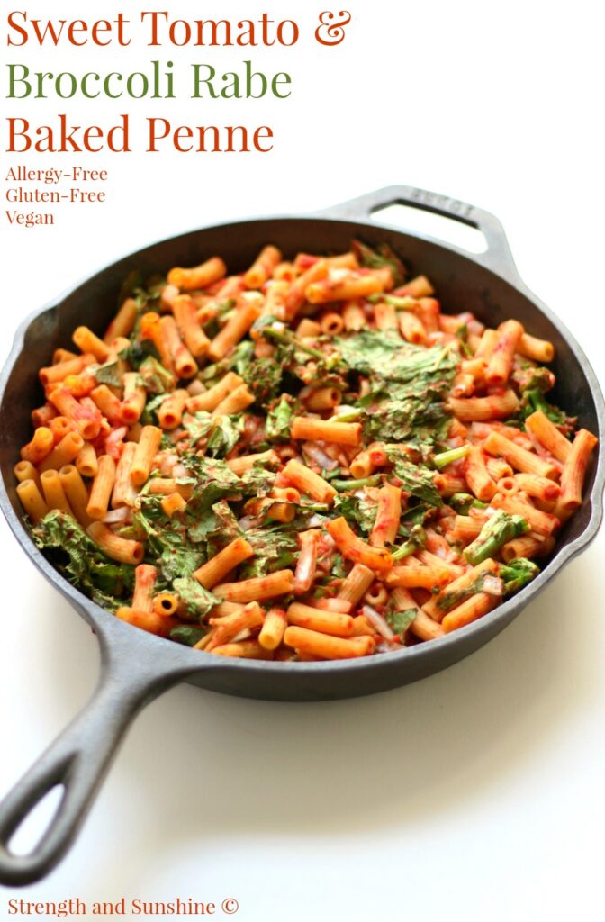 Low sodium pasta in a tomato sauce topped with green vegetables presented in a black skillet.