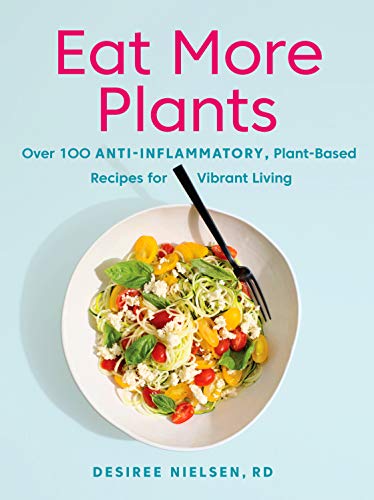 Eat more plants is a plant based cookbook cover with a blue background and a white bowl full of pasta and colorful vegetables.