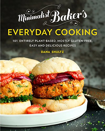 Minimalist bakers plant based book cover is black with a picture of veggie burgers presented on a white plate.
