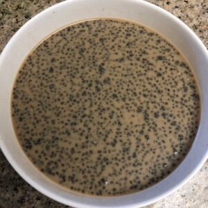 Chia seed coffee in a white mug, pictured top down.