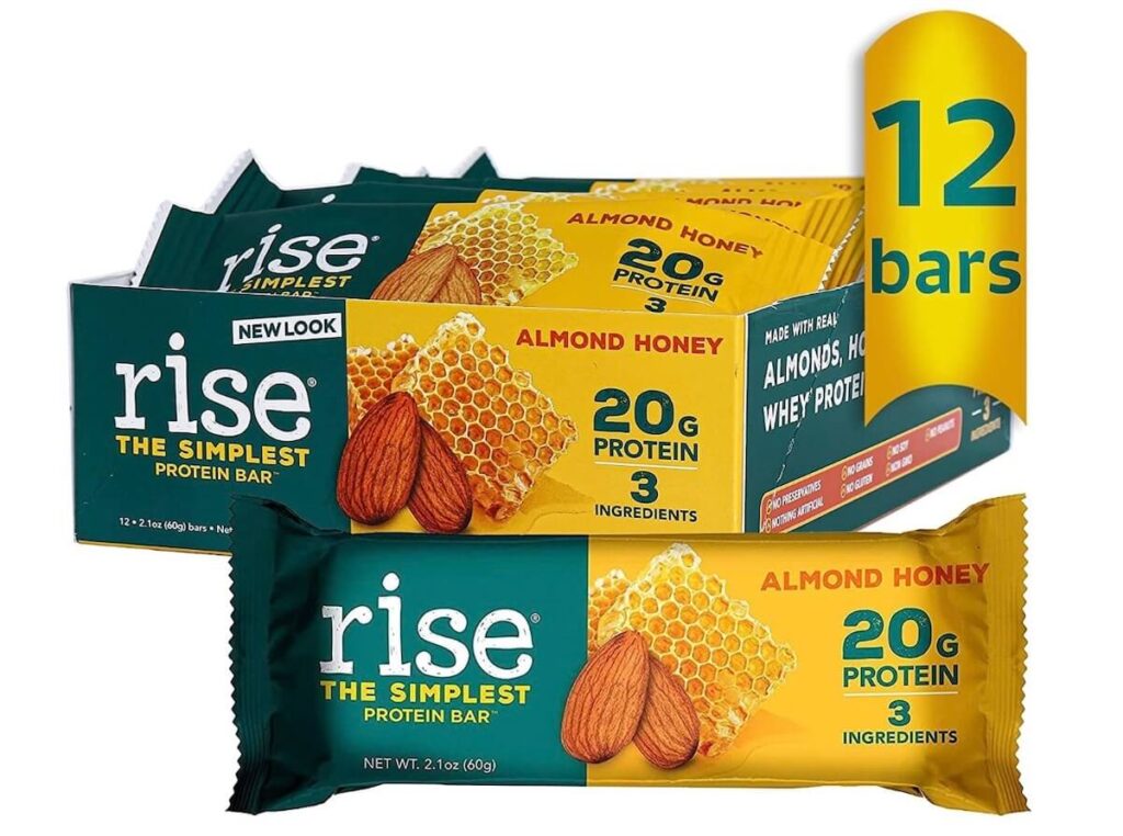 A box with the protein bar "Rise Bar". The packaging is green and yellow. 