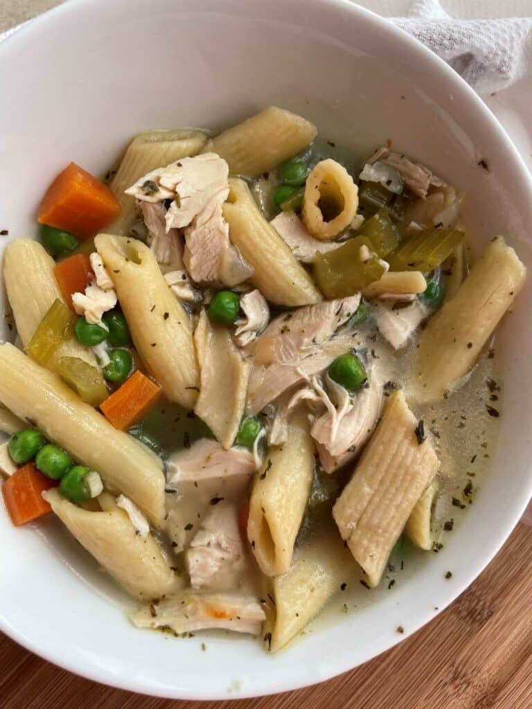 Low sodium chicken noodle soup pictured in white bowl.