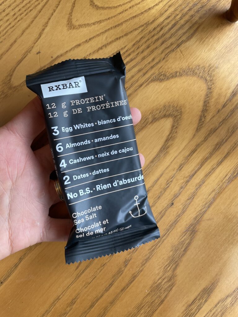RXBAR low sodium protein bar label on a wood background.