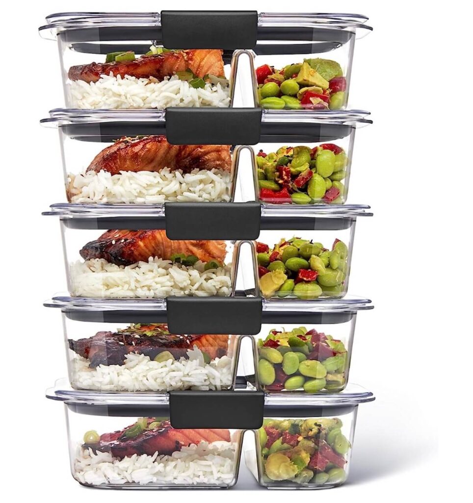 Meal prep containers stacked, filled with meals.