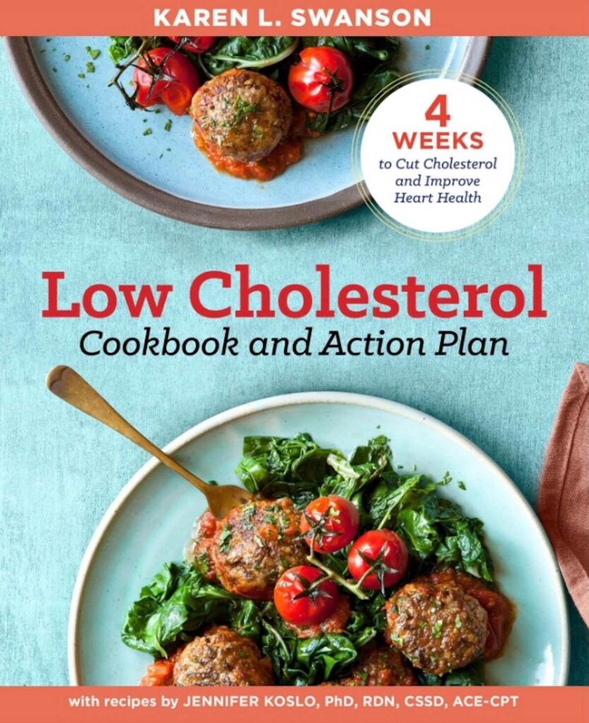 A blue cookbook with an image of meatballs and salad on the cover. The title reads "low cholesterol cookbook and action plan". 