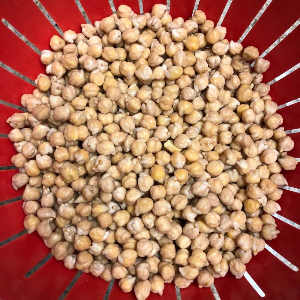 An image of drained chickpeas in a colander. 