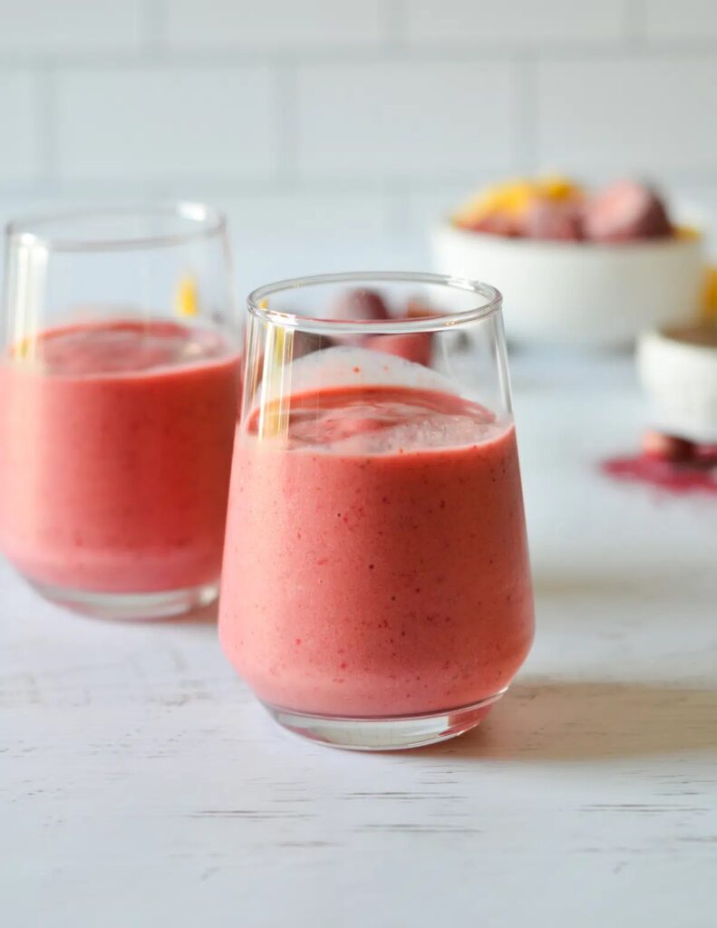 An image of two pink beetroot powder smoothies in a glass. 