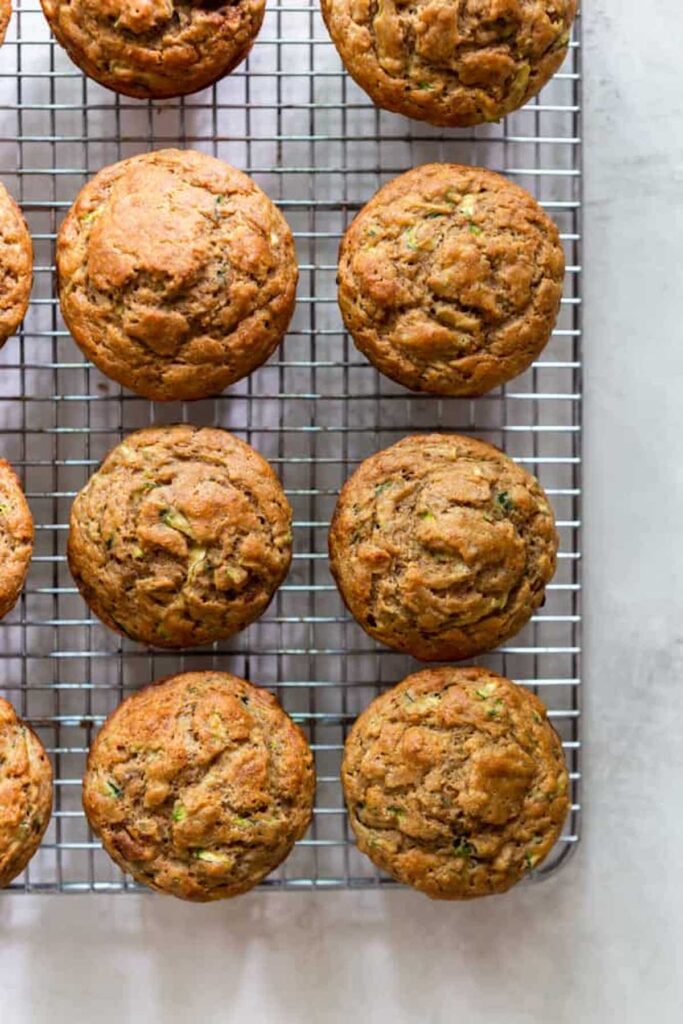 Healthy banana zucchini muffin pictured from above on a cooling rack. 