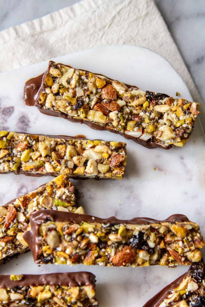 Energy bars with California prunes pictured on a marble slab.